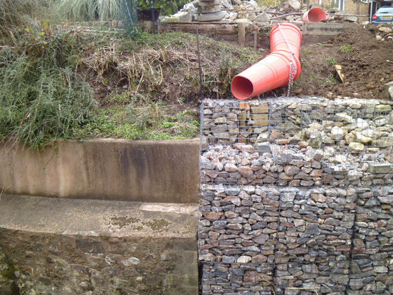 gabion wall next to a stone wall